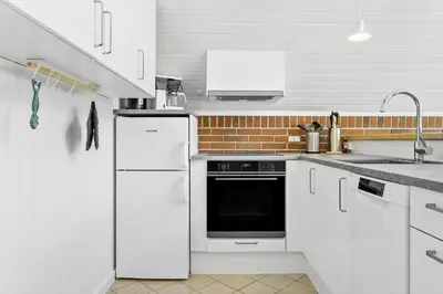 a white kitchen with a sink and a dishwasher at 479-Thisted-Kristinesvej-36 in Thisted