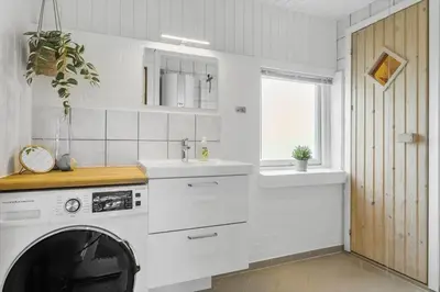 a white kitchen with a washing machine and a sink at 479-Thisted-Kristinesvej-36 in Thisted