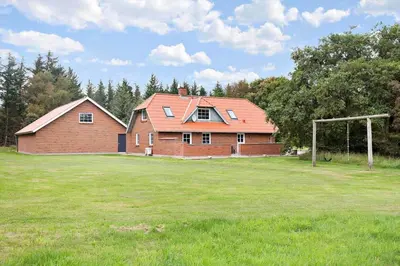 a large brick house with a soccer ball in a field at 456-Bedsted-Thy-Istrupvej-44 in Bedsted Thy