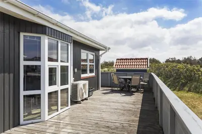 a deck with a table and chairs on a house at 581-Thisted-Nordsovej-32 in Thisted