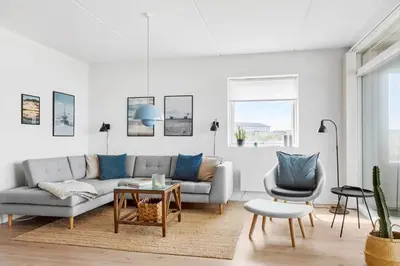 a living room with a couch and a chair at 556-Thisted-Havstokken-24-A in Thisted