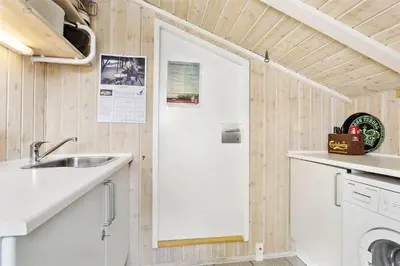 a small kitchen with a sink and a door at 796-Snedsted-Somaerkevej-66 in Snedsted