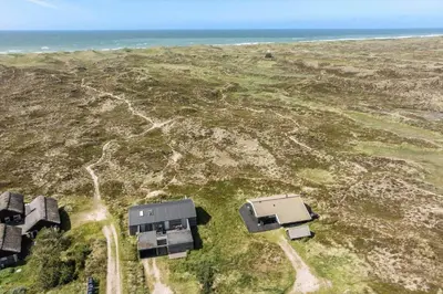 two houses on a field with the ocean in the background at 796-Snedsted-Somaerkevej-66 in Snedsted