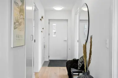 a hallway with a mirror and a black chair at 785-Thisted-Havstokken-32-A in Thisted