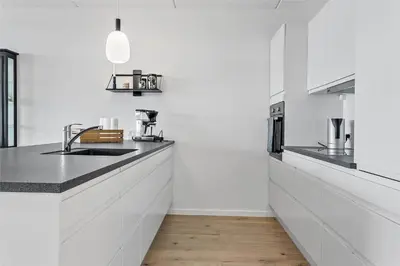 a white kitchen with a sink and a counter at 784-Thisted-Havstokken-30-A in Thisted