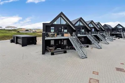 a large black house with stairs in front of it at 784-Thisted-Havstokken-30-A in Thisted