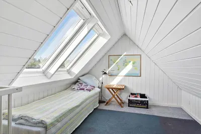 a bedroom with a bed in a attic with windows at 580-Thisted-Gaeslingevej-5 in Thisted