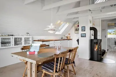 a kitchen with a wooden table and some chairs at 580-Thisted-Gaeslingevej-5 in Thisted