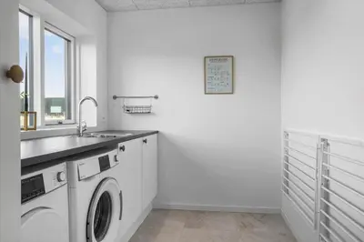 a white laundry room with a sink and a washing machine at 109-Thisted-Lyngbakken-9 in Thisted