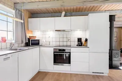 a white kitchen with white cabinets and appliances at 517-Thisted-Sigvej-10 in Thisted