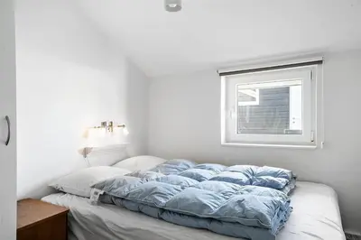 a bed in a white room with a window at 542-Thisted-Kuttervej-11 in Thisted