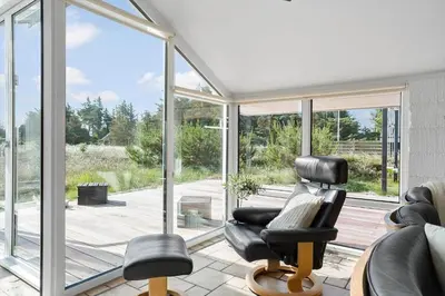 a living room with a chair and a window at 542-Thisted-Kuttervej-11 in Thisted