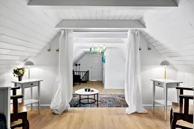 a white attic room with a white curtain and a table at 194-Vestervig-Vesterhavsvej-7-C in Vestervig