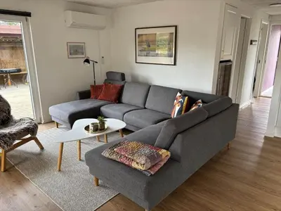 a living room with a gray couch and a table at 162-Thisted-Molgaardsvej-62 in Thisted