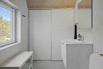a white bathroom with a sink and a window at 716-Thisted-Kristinesvej-34 in Thisted