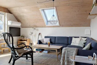 a living room with a blue couch and a table at 716-Thisted-Kristinesvej-34 in Thisted