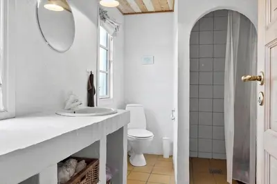 a white bathroom with a sink and a toilet at 529-Thisted-Nordsovej-24 in Thisted