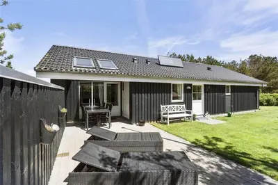 a house with a patio with a table and chairs at 344-Thisted-Flyndervej-20 in Thisted