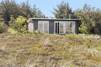 a small house on top of a grass field at 151-Thisted-Havbovej-39 in Thisted