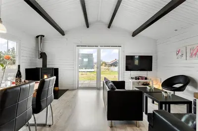 a living room with chairs and a table and a television at 567-Thisted-Fiskervej-67 in Thisted