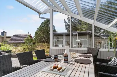 a patio with a table and chairs and a white pergola at 713-Thisted-Tranebaervej-10 in Thisted