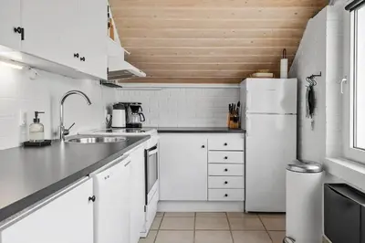 a white kitchen with a sink and a refrigerator at 382-Thisted-Kristinesvej-2 in Thisted