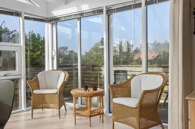 a room with three chairs and a table and windows at 1332-Thisted-Flyndervej-22 in Thisted