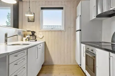 a kitchen with white cabinets and a sink and a window at 1322-Snedsted-Lykkens-Hab-21 in Snedsted