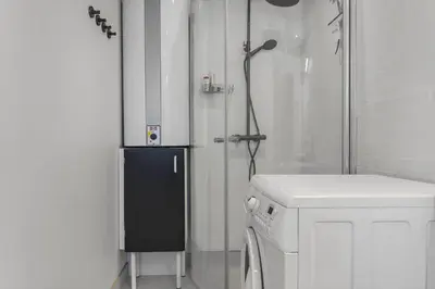 a bathroom with a shower and a washing machine at 1329-Thisted-Nordsovej-226 in Thisted