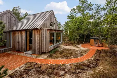 a home with a gambrel roof and a brick patio at 1061-Thisted-Spanggardsvej-85-B in Torsted