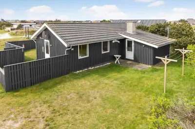 a black and white house with a yard at 1336-Thisted-Nordsovej-50 in Thisted
