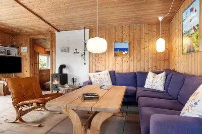 a living room with a purple couch and a table at 1336-Thisted-Nordsovej-50 in Thisted