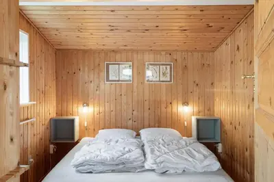 a bedroom with a bed in a wooden wall at 1336-Thisted-Nordsovej-50 in Thisted