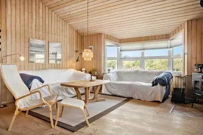 a living room with a couch and a table at 1062-Thisted-Mombak-45 in Torsted