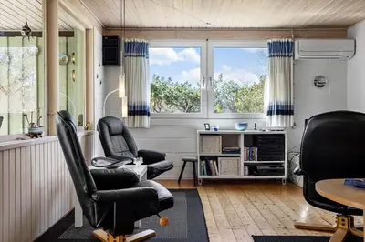 a living room with two chairs and a table at 246-Thisted-Pighvarvej-16 in Thisted