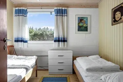 a bedroom with two beds and a window at 246-Thisted-Pighvarvej-16 in Thisted