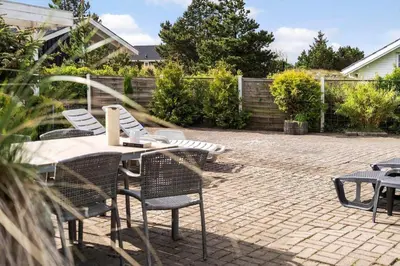 a patio with a table and chairs on a brick patio at 1342-Thisted-Mose-Bolle-Vej-8 in Thisted