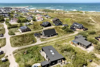 an aerial view of a neighborhood with houses and the ocean at 1338-Thisted-Havbovej-15 in Thisted