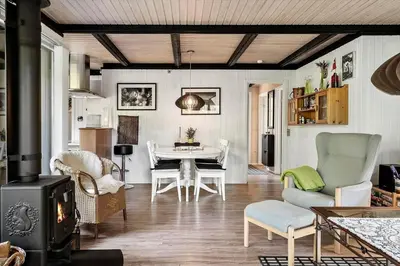a living room with a table and chairs and a stove at 1344-Vestervig-Hedevej-43 in Vestervig