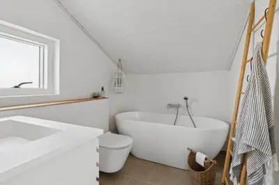 a white bathroom with a tub and a toilet at 1064-Thisted-Klitstien-25 in Torsted