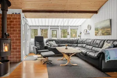 a living room with a couch and a table at 1326-Thisted-Blabaervej-6 in Thisted