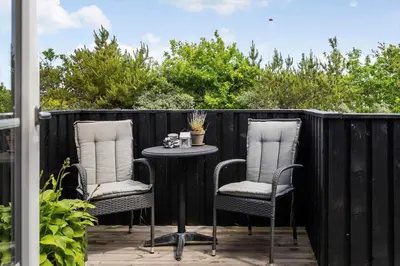 two chairs and a table on a patio at 1350-Thisted-Blabaervej-22 in Thisted