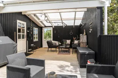 an outdoor patio with chairs and a table at 1350-Thisted-Blabaervej-22 in Thisted