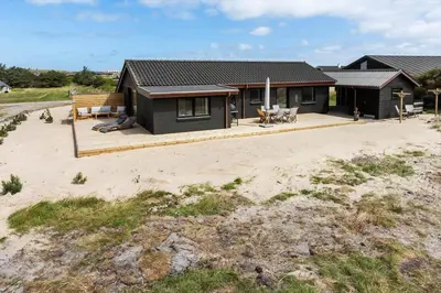a house on the beach with a deck at 1068-Thisted-Klovborgsti-5-A in Torsted