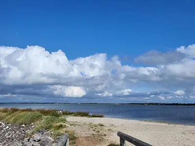 a body of water with a bench on a beach at Holiday home for family in Denmark in Løgsted