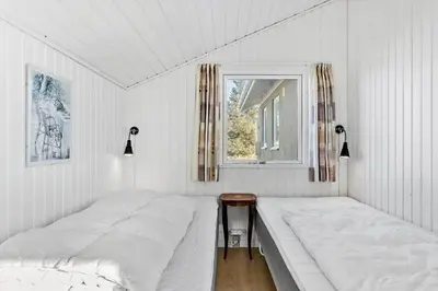 a white bedroom with two beds and a window at 148-Thisted-Fiskervej-74 in Thisted