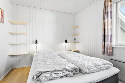 a white bedroom with a large bed in it at 148-Thisted-Fiskervej-74 in Thisted