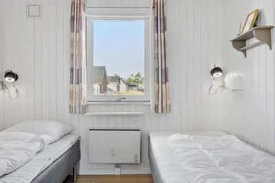 two beds in a room with a window at 148-Thisted-Fiskervej-74 in Thisted