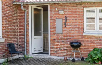 a door to a brick house with a grill next to it at Lovely Home In Thyholm With Wifi in Thyholm