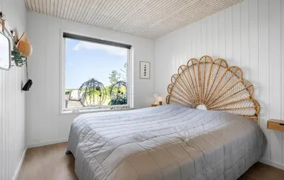 a bedroom with a large bed with a large window at 4 Bedroom Cozy Home In Fur in Fur